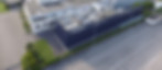Aerial view showcasing two buildings of Golfera's company in Colecchio. One building is blue with a gigantic 'Golfera' text, while the other is white surrounded by a lush green lawn.