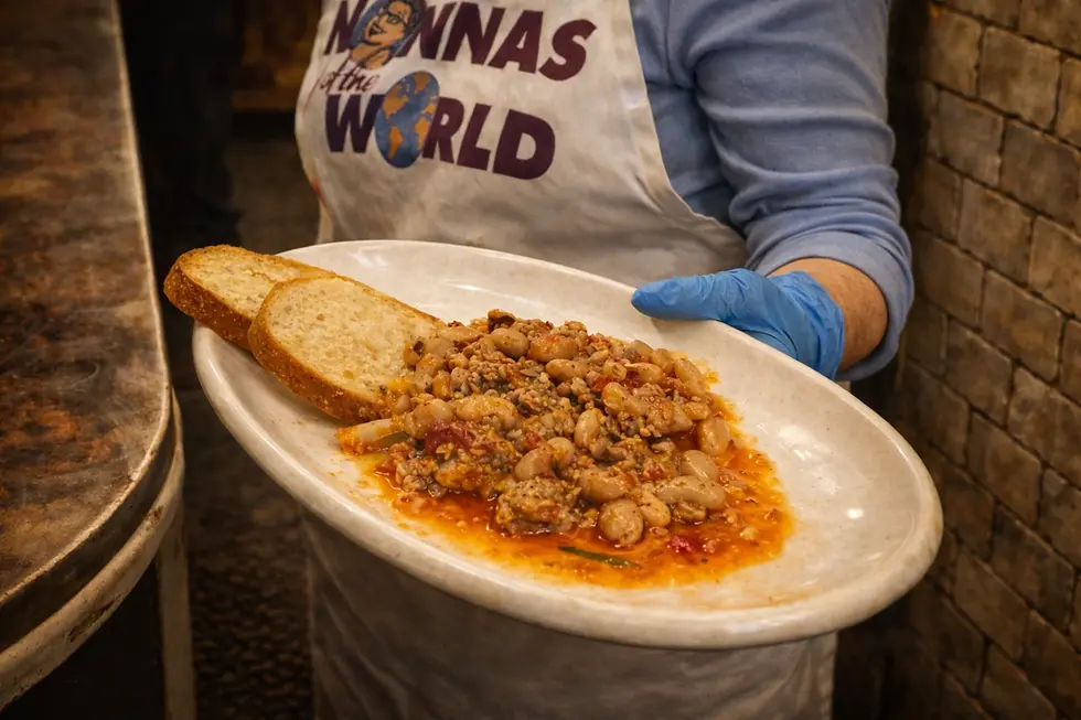 Nonna Sabbia serving Fagioli all’Uccelletto with sausage and cannellini beans in rustic tomato sauce at Nonna’s of the World restaurant.