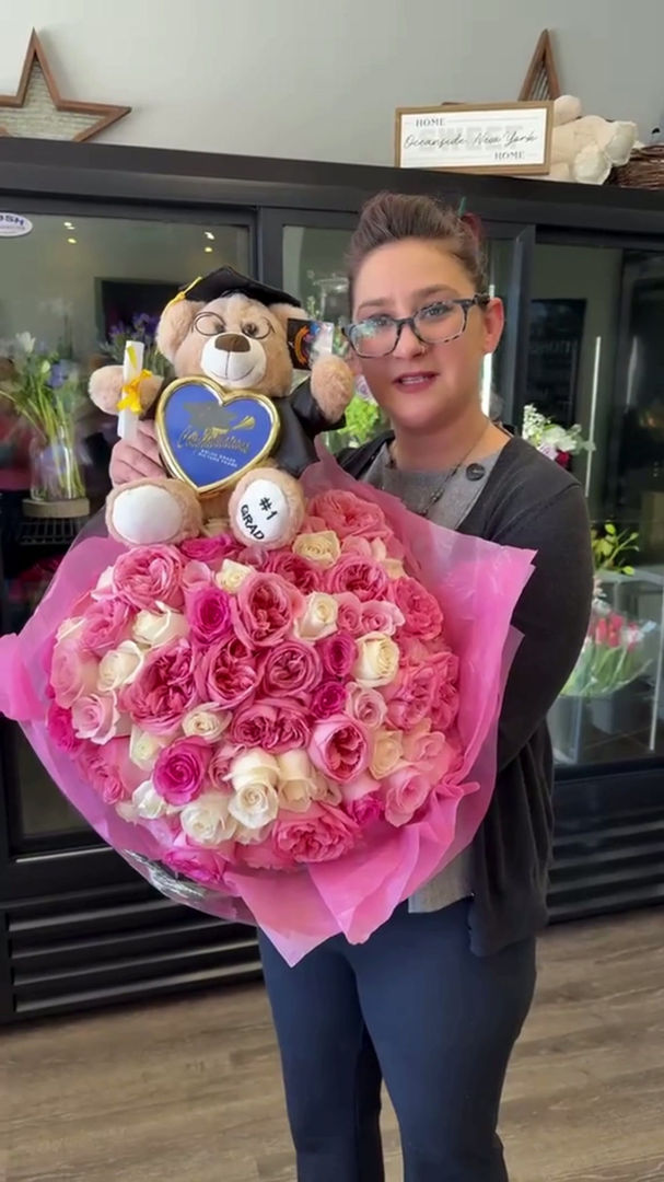 Nina holding a luxury pink and ivory garden rose bouquet with graduation bear at Flowers by Mike NY