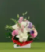 Romantic pink, white, and lavender Valentine’s flower arrangement with roses, orchids, and lisianthus from a florist in Ocean