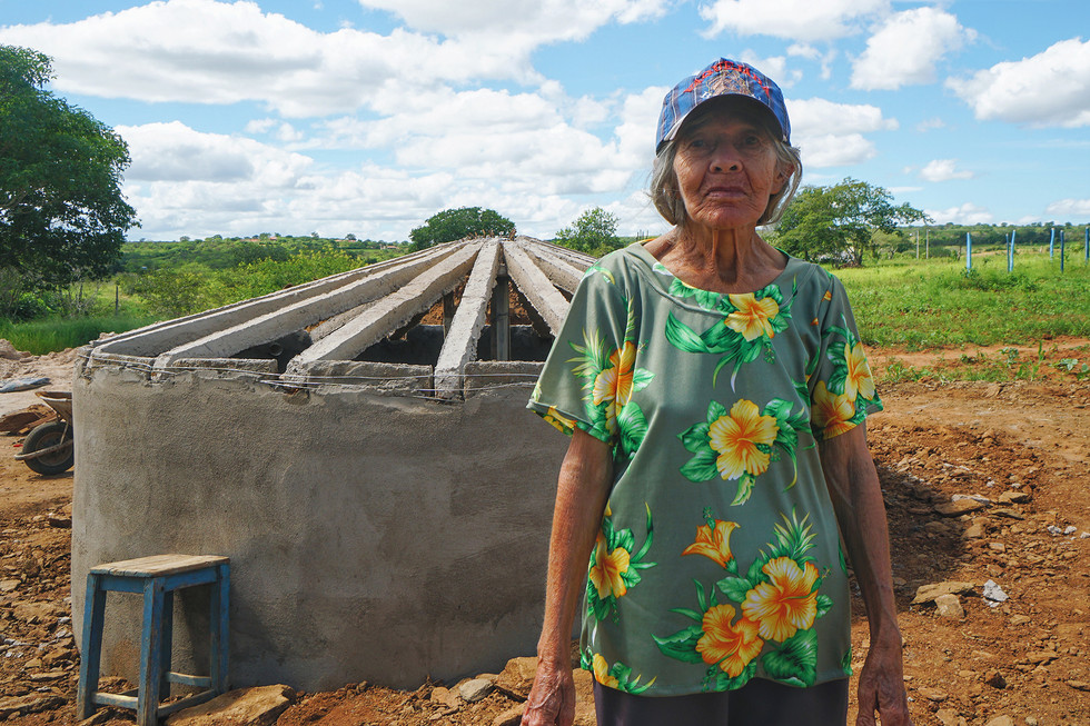 Woman in front of new water cistern