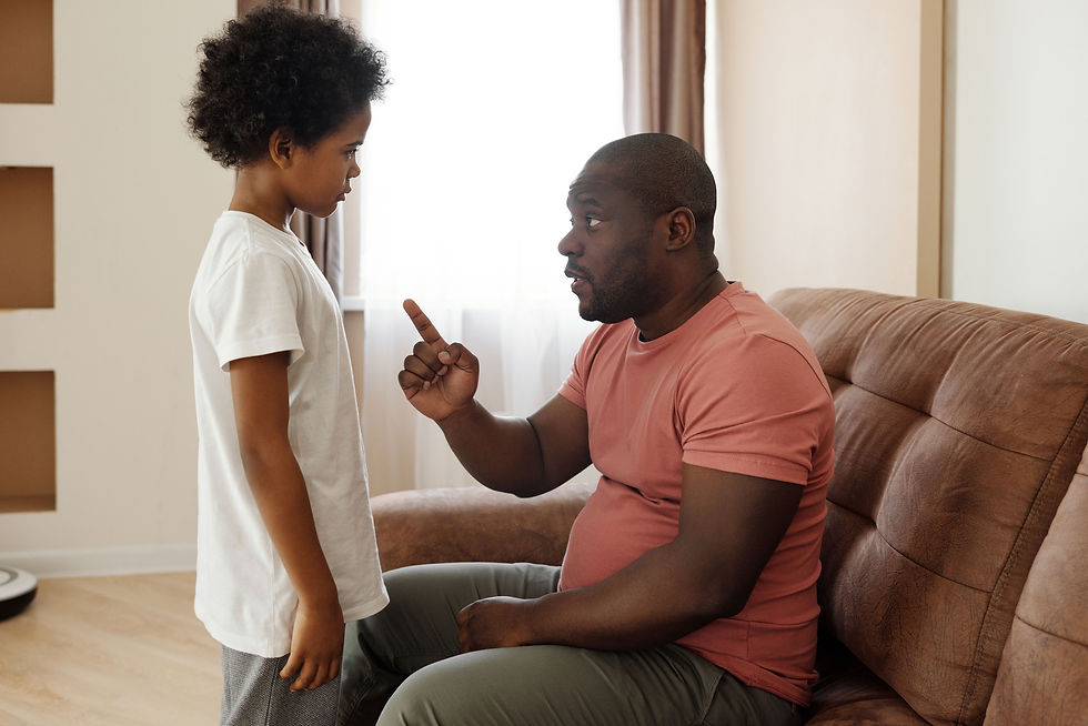 Eye-level view of a parent calmly talking to a child at the kitchen table