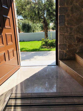 Open entrance door to the front of the villa