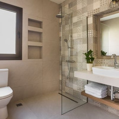 Shower in a bathroom with separation made of glass