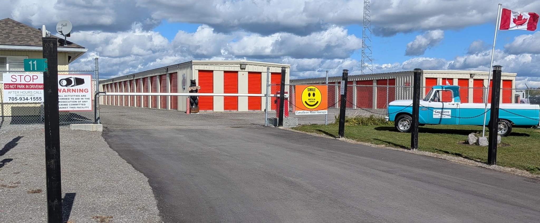 Cavaliere Mini Storage entrance, orange storage units and turquoise truck at 11 Walsh Road in Lindsay