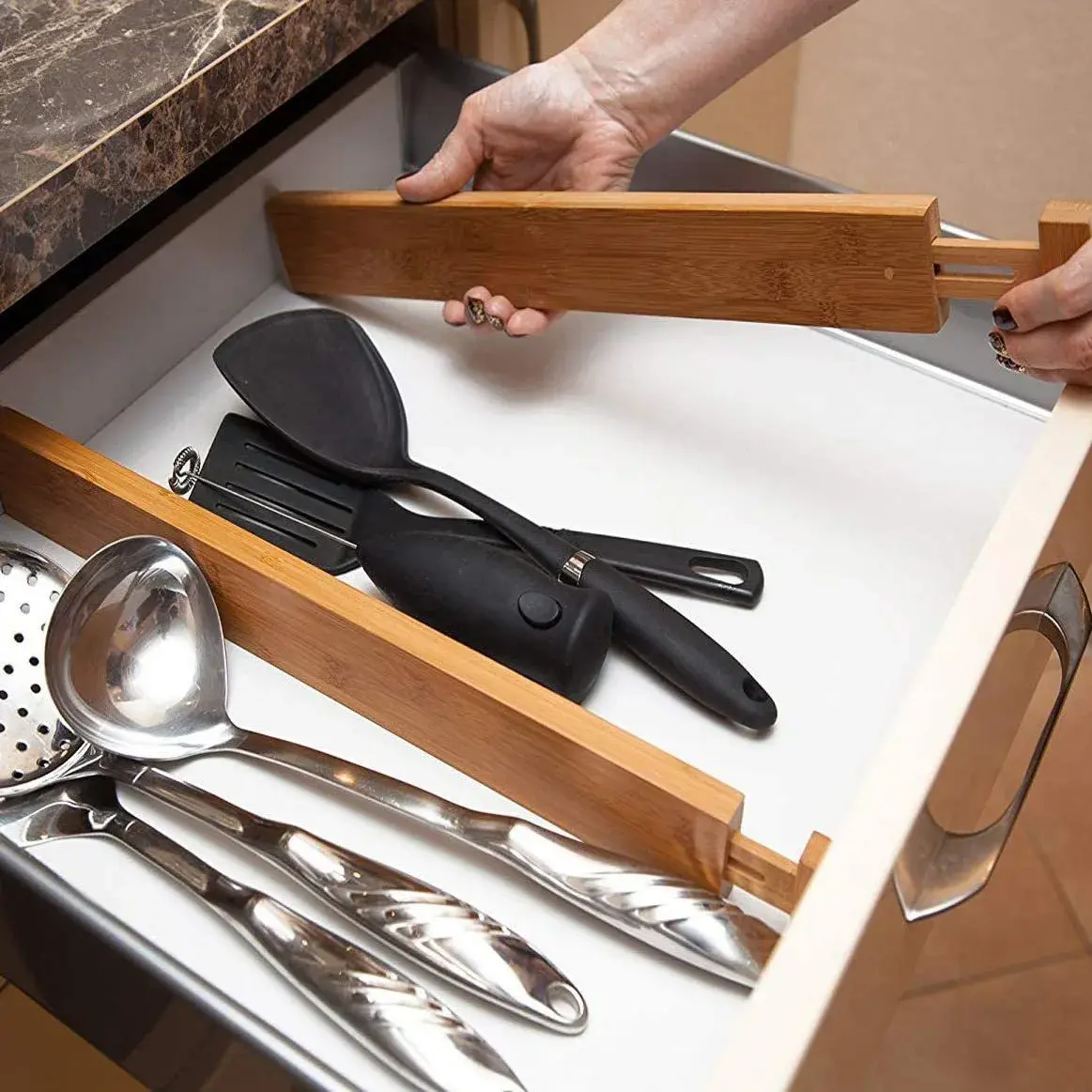 Bamboo drawer divider in kitchen drawer