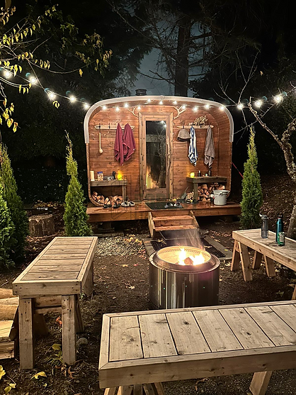 cedar barrel sauna with glass door and wood fired stove