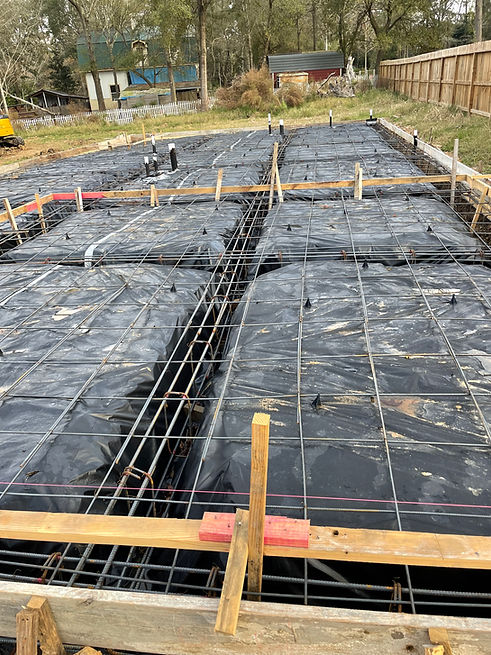 Residential concrete slab with steel rebar installed before foundation concrete pour.