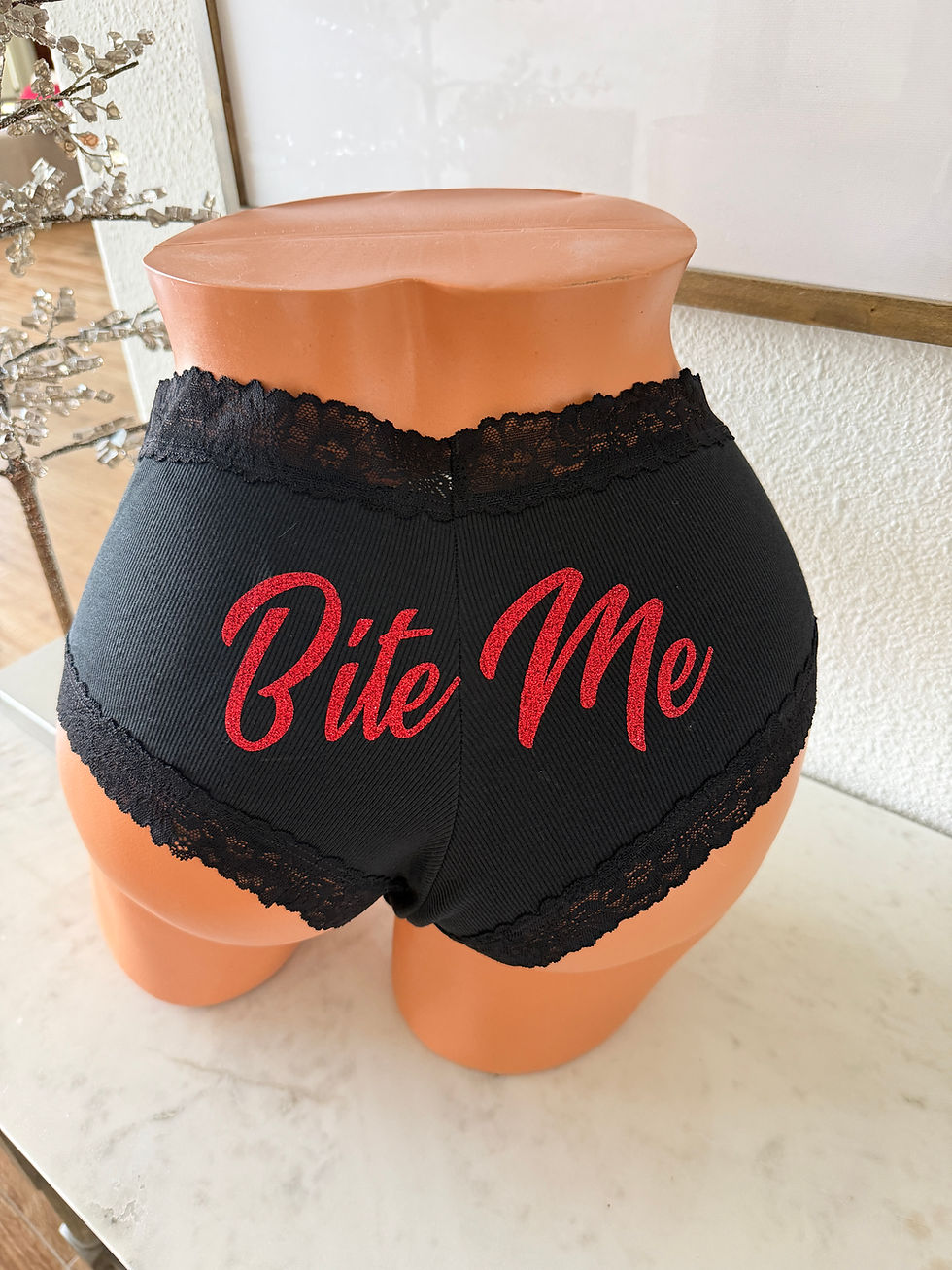 Black panty with Bite Me in red glitter on the back