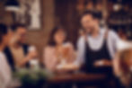 happy-waiter-giving-food-group-people-who-are-drinking-beer-bar.jpg