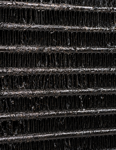 Industrial heat exchanger/radiator with contamination and blockage requiring cleaning and overhaul.