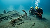 Divers searching a sunken shipwreck and anchor underwater