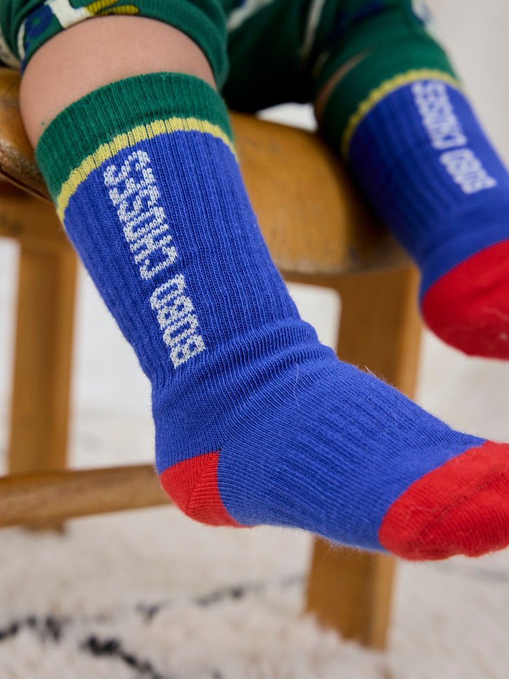 Close-up of child wearing Bobo Choses Color Block Long Socks in blue with red toes