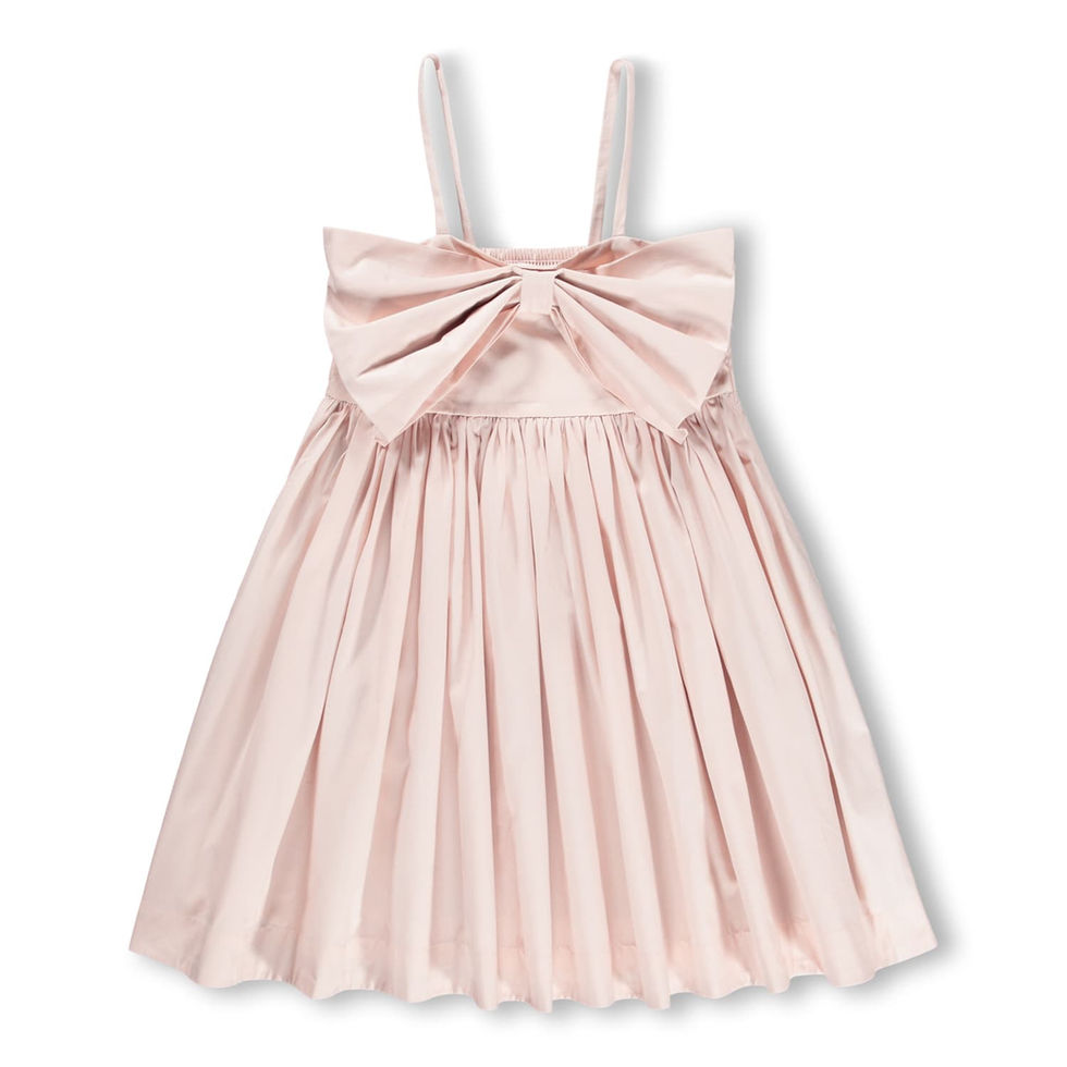 Light pink children’s sleeveless dress with thin straps, a large bow detail on the chest, and a gathered skirt.