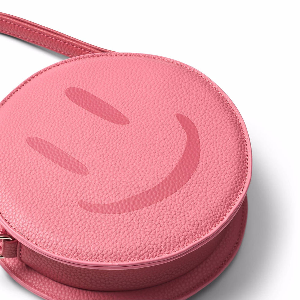Close-up of the round pink bag showing the embossed smiley face detail.