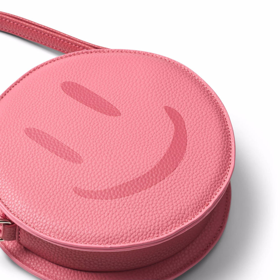 Close-up of the round pink bag showing the embossed smiley face detail.