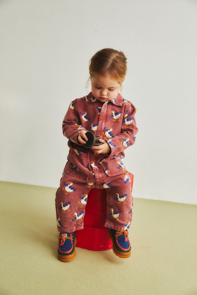 Child wearing La Oca All Over Woven Overall, playing with a red stool.
