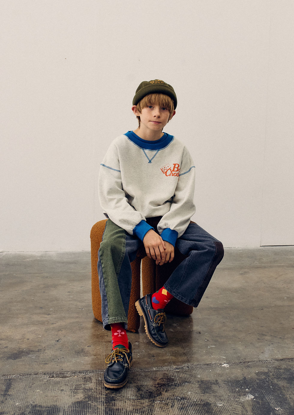 Child sitting on chair wearing multicolor Color Block Denim Pants by Bobo Choses
