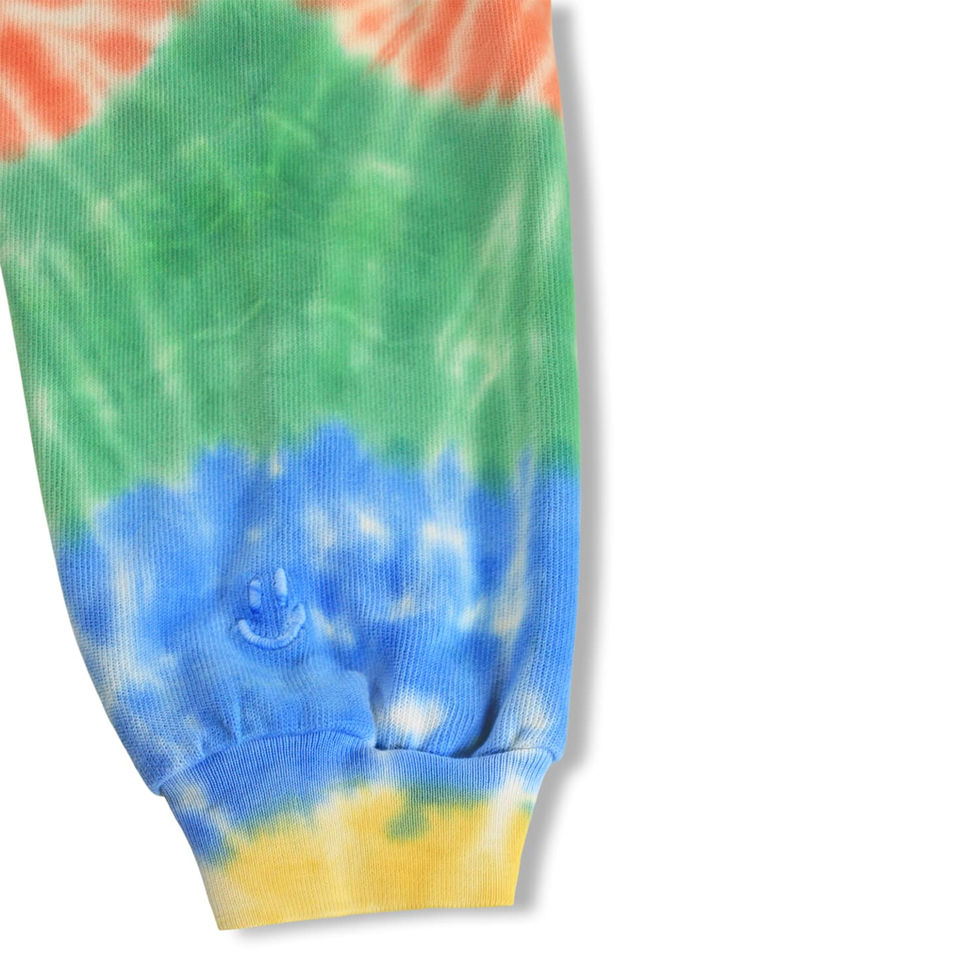 Close-up of the leg showing cuff and tie-dye color transitions.