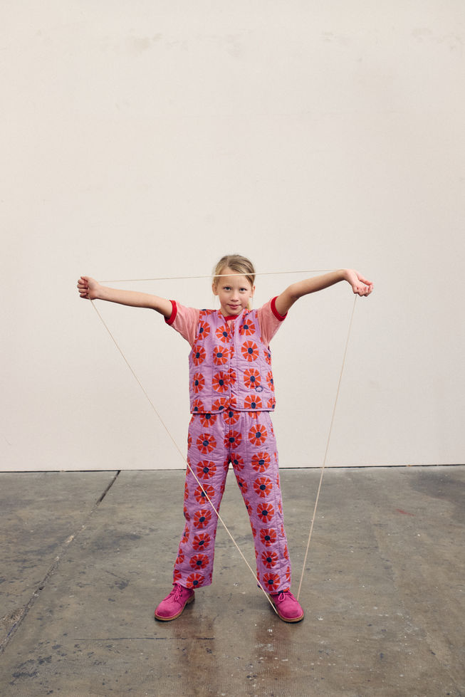 Child wearing the vest with matching kaleidoscope trousers.