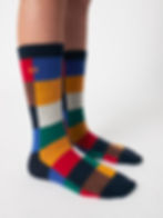 Model wearing Multicolor Tiles Long Socks in bright patchwork colors