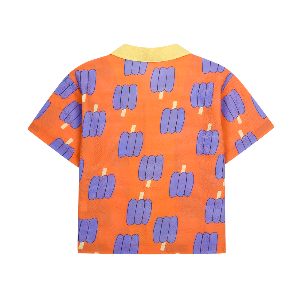 Back view of orange children’s shirt with purple popsicle pattern and yellow collar.