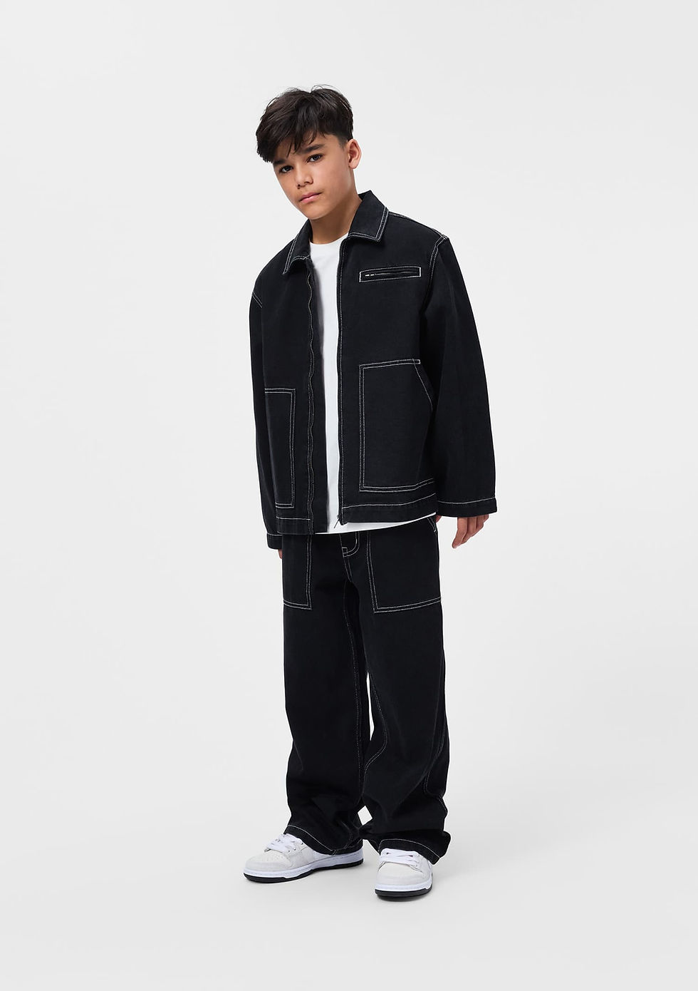 Child standing and facing forward, wearing the black jacket with matching pants.