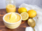 lemon curd on a cutting board with sliced lemons