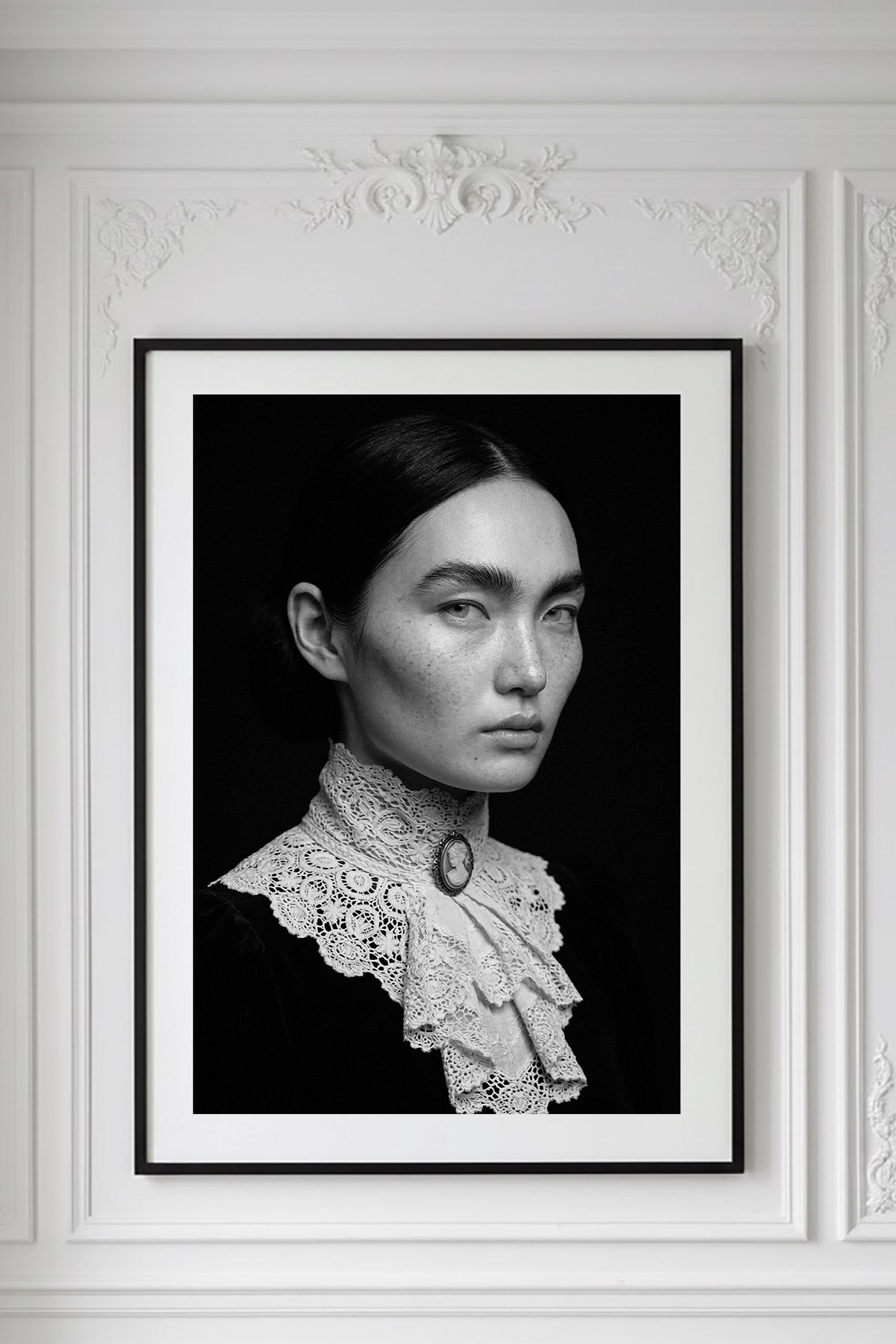 Irene — black-and-white fine art portrait, dark hair against a lace collar with a cameo at the throat, by HRÈ / Katarzyna K.
