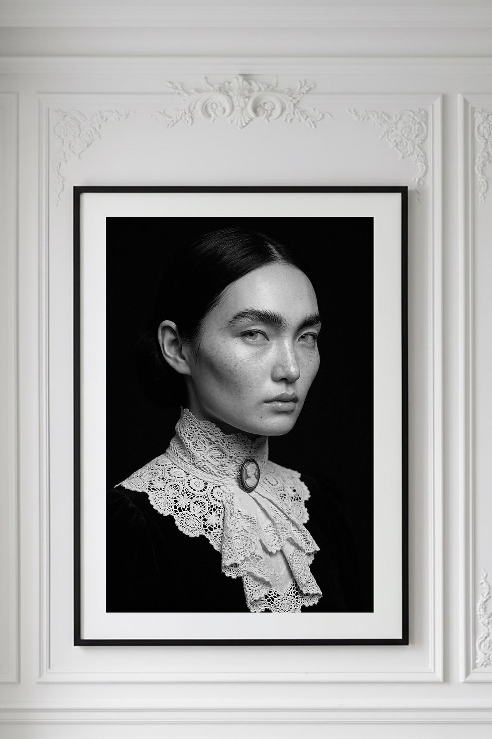 Irene — black-and-white fine art portrait, dark hair against a lace collar with a cameo at the throat, by HRÈ / Katarzyna K.