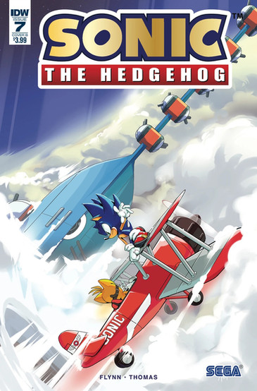 Cover of Sonic The Hedgehog #7 (Adam Bryce Thomas variant) shows Tails flying his biplane in the sky next to a giant airship with a long platform sticking out the front with turrets on either side of the platform. There's also a big turret on top of the airship. Standing is standing on top of the wings of the biplane with a smirk on his face as he's holding on with one hand and the other hand is held off to his side.