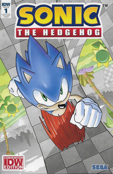 Cover of Sonic The Hedgehog #1 (Tracy Yardley C2E2 variant) has a close up of Sonic as he runs through a loop. His legs are just a blur while he's smiling at the reader. The world  behind Sonic is upside down as he's upside down in the loop. The background shows mountains, grassy fields, and a lake. The loop, the lake, and the mountains are all in black and white while Sonic and the field and trees directly behind him are in color.