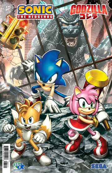 Cover of Sonic the Hedgehog X Godzilla #1 (Mico Suayan variant) has Sonic, Tails, and Amy standing in rubble. There's a car stuck in the rubble, and a traffic light bent over above them. Behind them is a skyscraper and in the reflection of it you can see Godzilla staring down the trio.