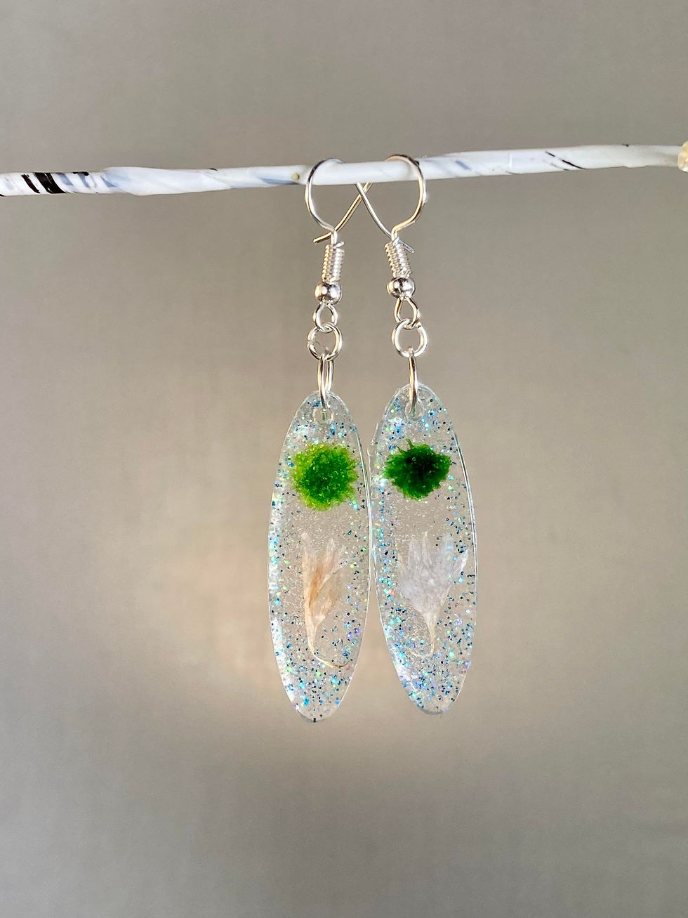 Green and blue resin earrings front view.