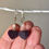 Thumbnail: heart earrings front view in hand for size reference