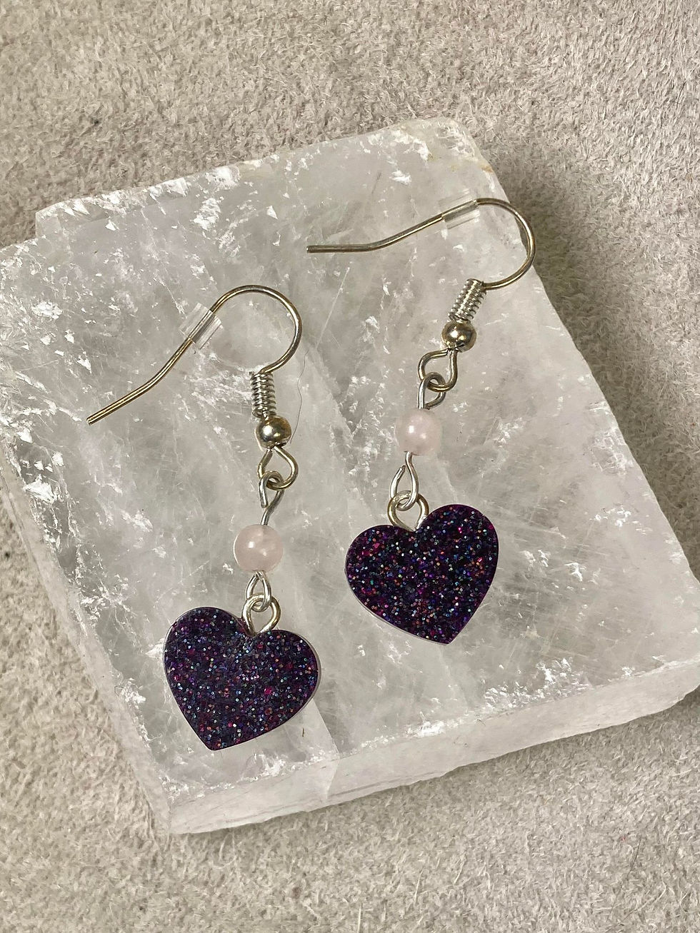 Thumbnail: heart earrings front view laying on flat crystal