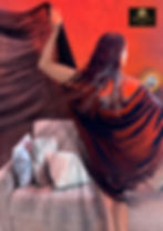 Mujer de espaldas levantando una tela frente a un sofá