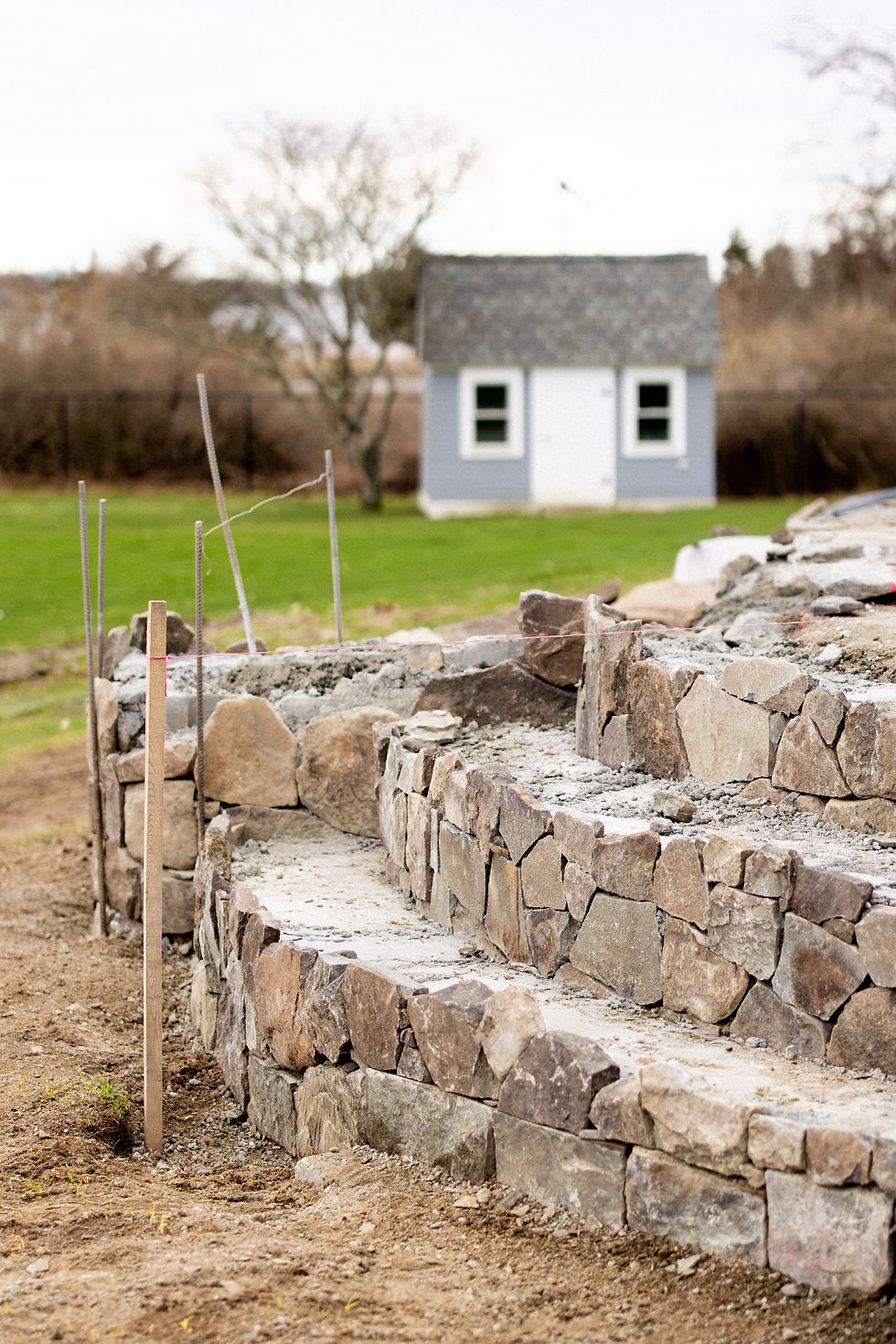 Curved stone wall and steps being built below the house, Rhode Island