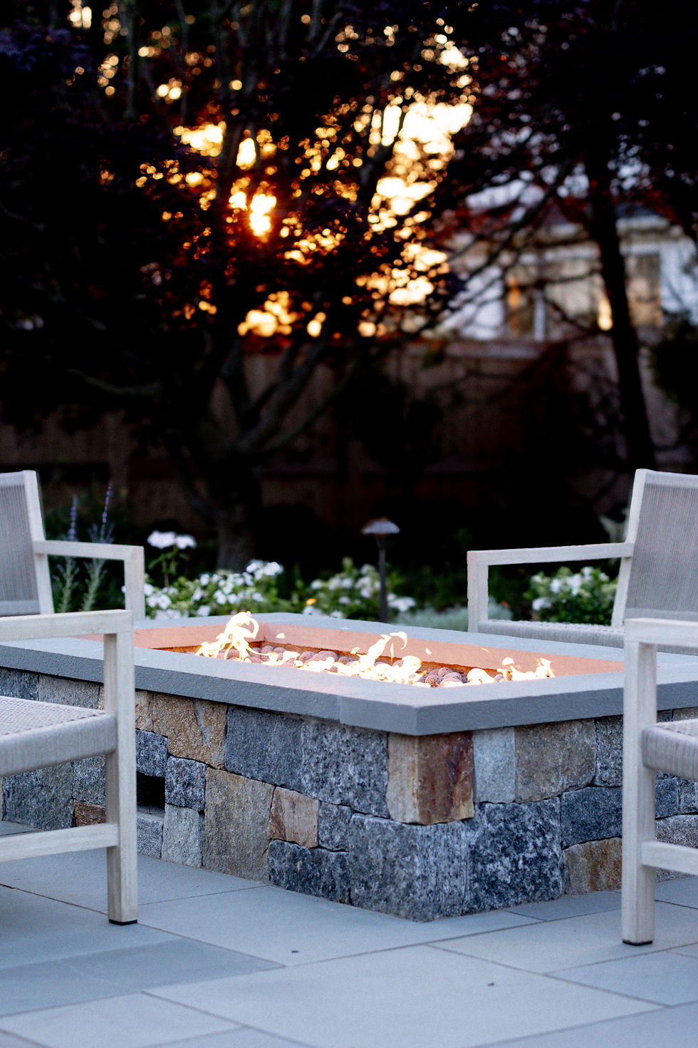 Stone fire bowl and chairs at dusk, Rhode Island