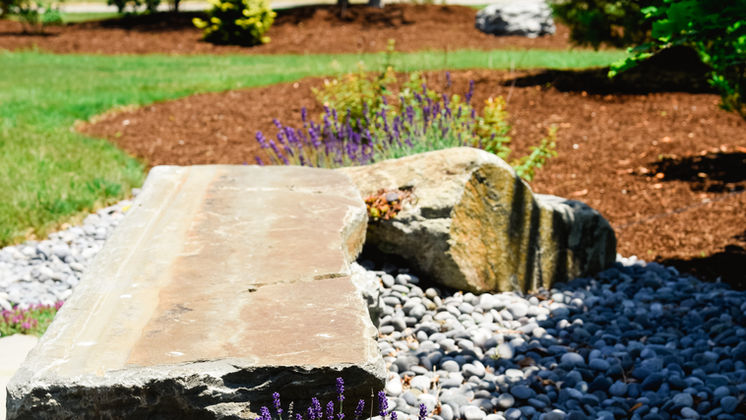 Granite slab bench with lavender and river-stone bed — O'Connor Design Build, Rhode Island