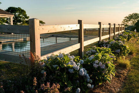 Wood fencing surrounding built-in pool with landscape work