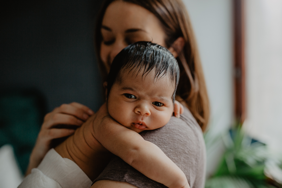 newborn baby on mother's shoulder