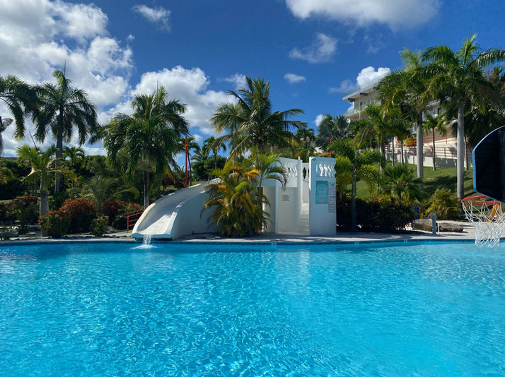 Refreshing pool with waterslide at Fajardo Inn Resort