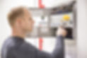 Technician checks fire panel in data cen