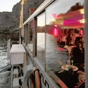 Sunset on a steam boat with the bride and groom dancing inside