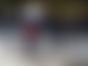 Mulher caminha carregando cesto de pão na cabeça, em frente a fileira de policiais