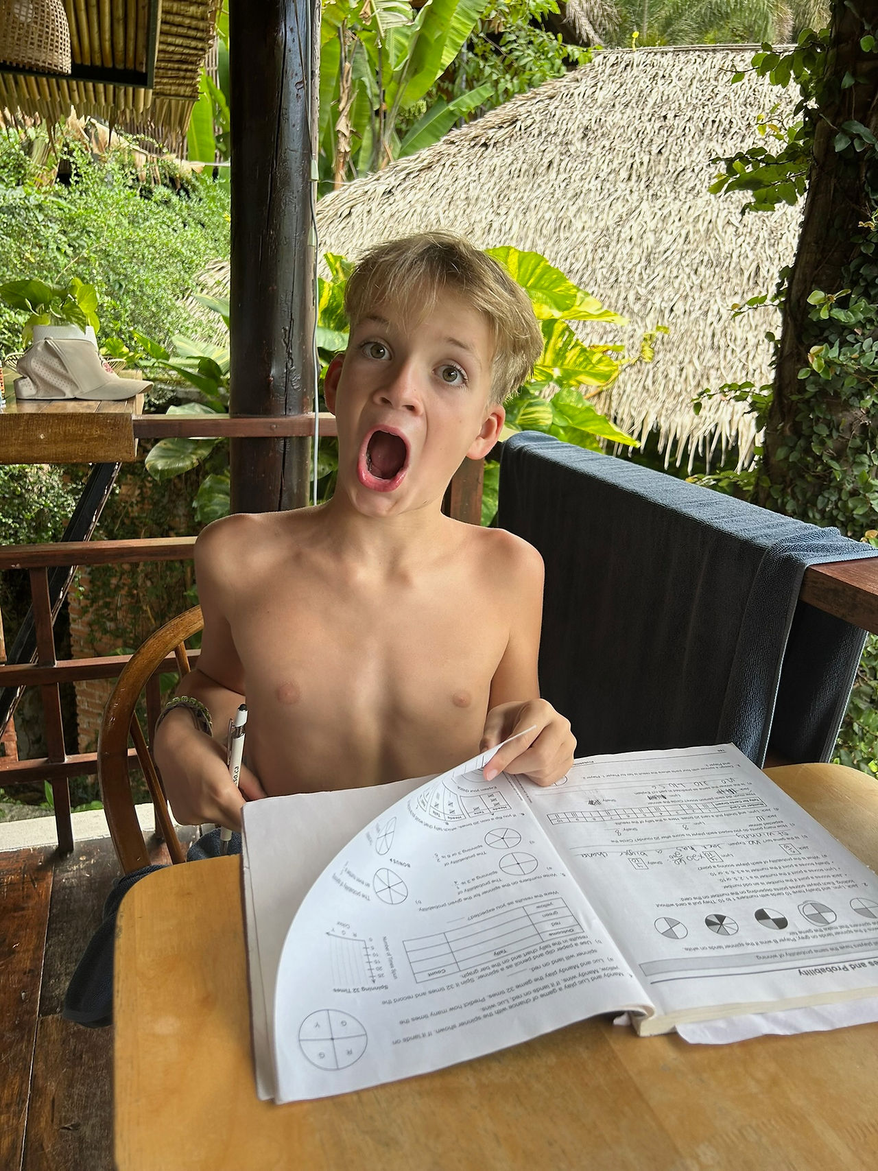 Jasper excited about his last page of his math workbook