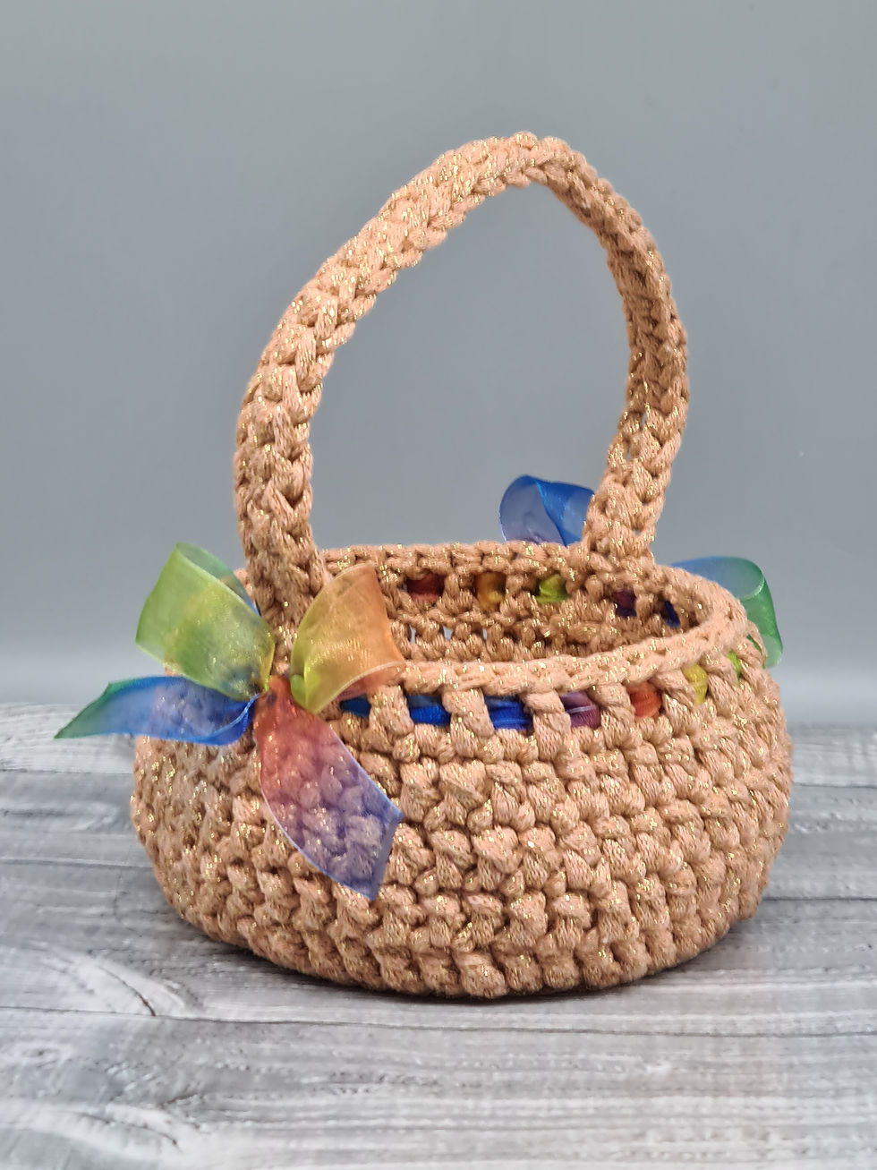 Thumbnail: Large rose gold crochet basket with rainbow ribbon