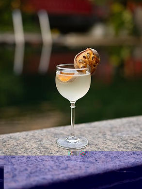 Geji Martini cocktail made with SONKLIN, garnished with dried bael fruit (matoom), served in a nick and nora glass
