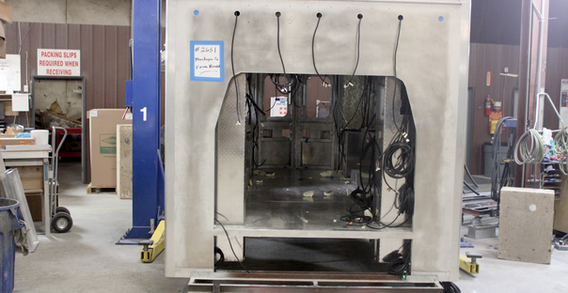 Front wall view of Muskogee #2651 on welding and fabrication lift. Type III ambulance from Custom Truck and Body Works, Inc.